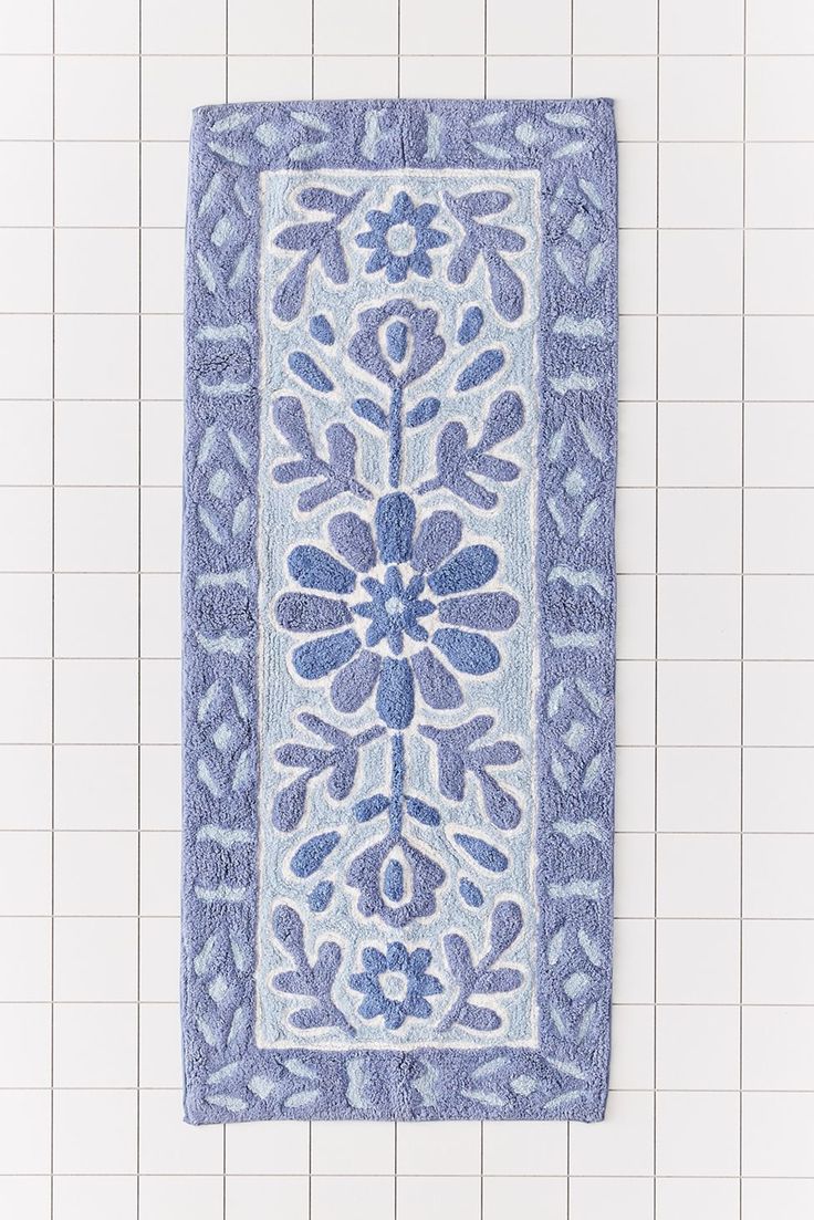 a blue and white rug hanging on the wall