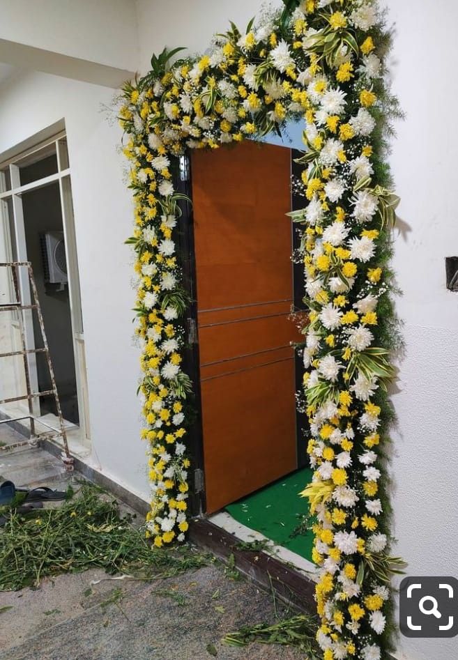 a doorway decorated with yellow and white flowers