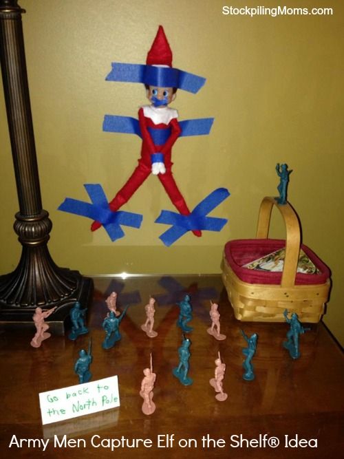 an assortment of toy soldiers and elf figurines on a table next to a lamp post