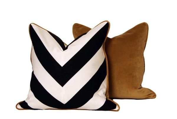 two black and white pillows sitting next to each other