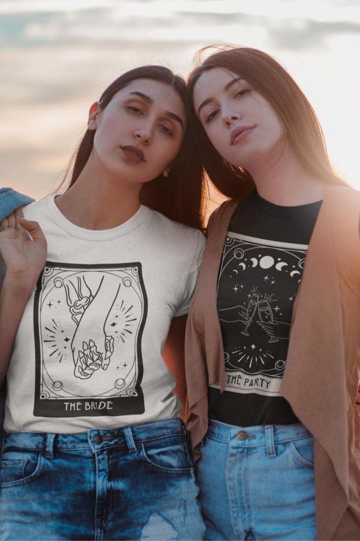 two women standing next to each other wearing t - shirts with the same image on them