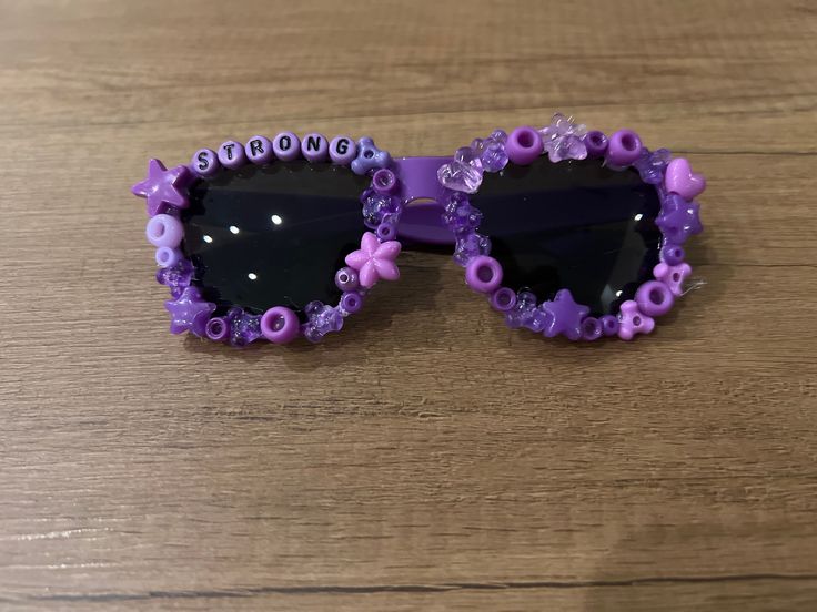 Cool sunglasses to wear in the summer. We can also do other motivational words on your sunglasses- check out our custom listings. This specific one is purpletastic Fun Purple Summer Sunglasses, Fun Purple Sunglasses For Summer, Fun Purple Tinted Sunglasses, Purple Tinted Fun Sunglasses, Fun Purple Sunglasses For The Beach, Fun Purple Sunglasses For Beach, Casual Purple Glass Sunglasses, Adjustable Purple Sunglasses With Gradient Lenses, Beaded Sunglasses