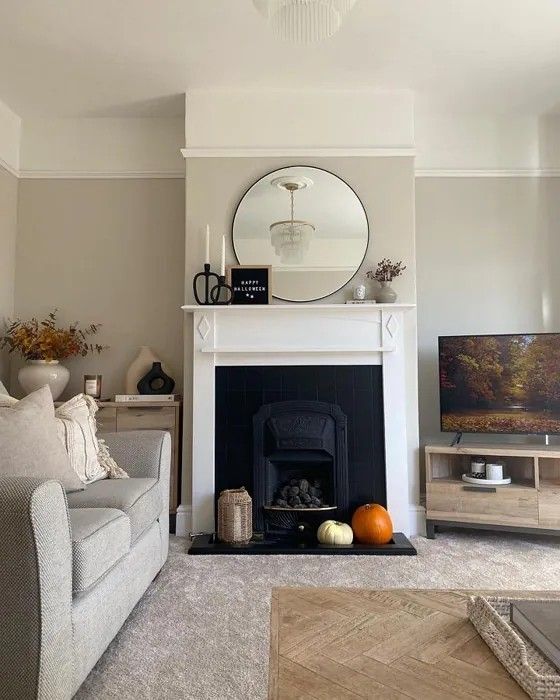 a living room filled with furniture and a flat screen tv on top of a fireplace