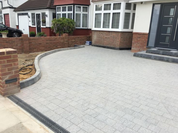 a brick driveway in front of a house