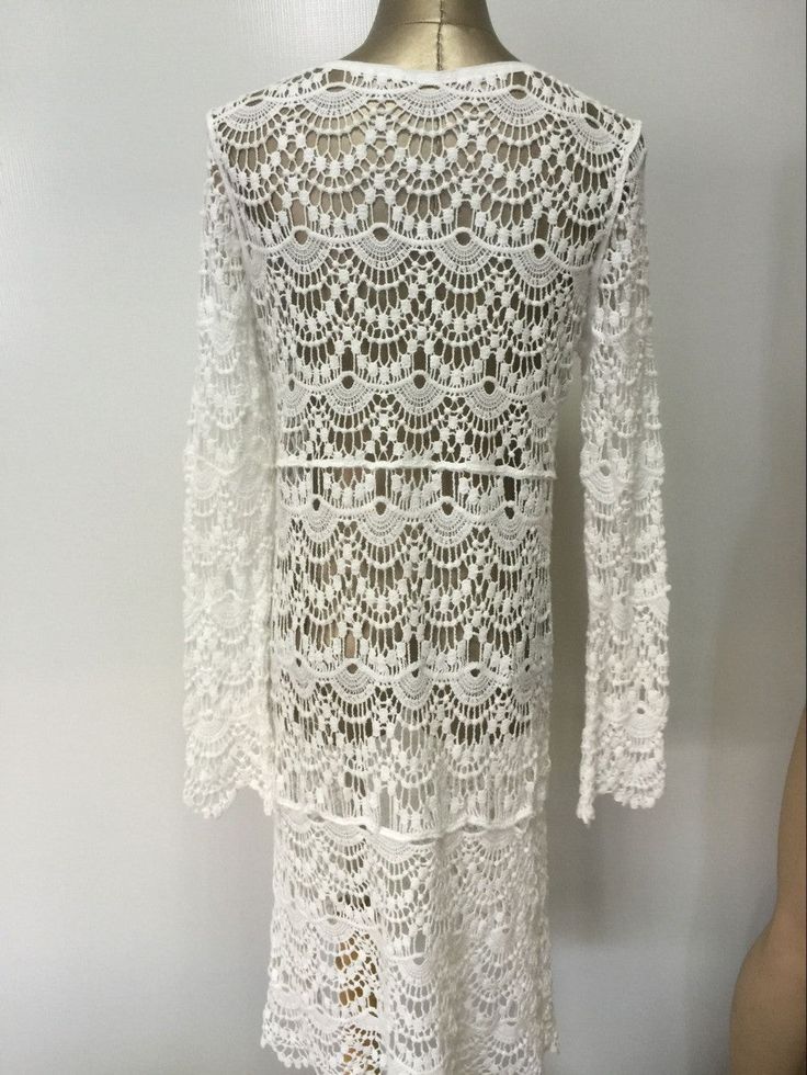 Material: Acrylic, CottonDecoration: Hollow OutSleeve Length: Full SleeveCollar: V-Neck Crochet Lace Beach Dress, V-neck Crochet Lace Dress For Beach Cover-up, Long Sleeve Hollow Out Beachwear Dress, Elegant Crochet Top For Beach, Elegant Crochet Trim Top For Beach, Elegant White Crochet Beach Dress, Elegant White Crochet Beach Cover-up Dress, Bohemian Long Sleeve Dress With Hollow Out Details, Elegant White Crochet Dress For Beach