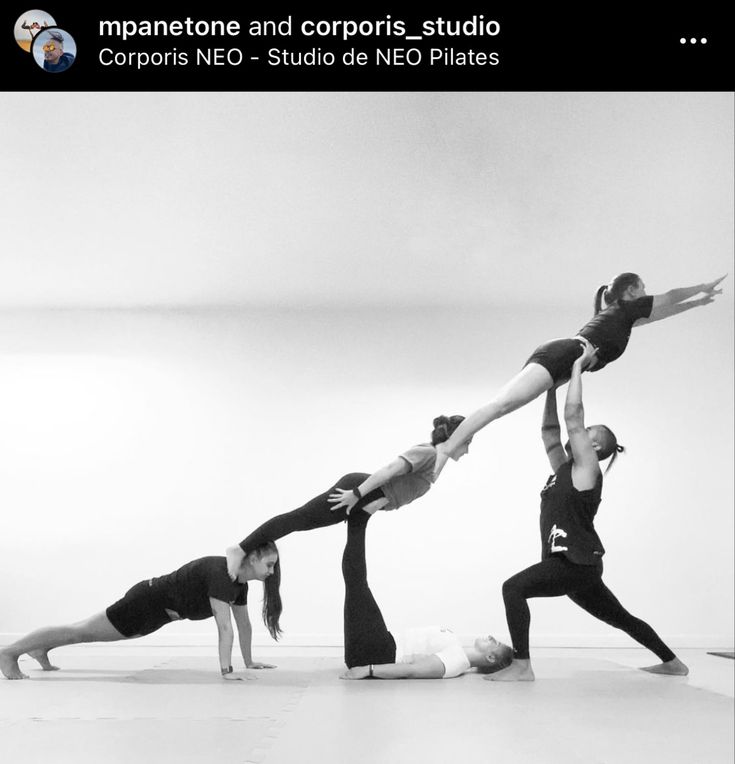 a group of people standing in a line doing yoga