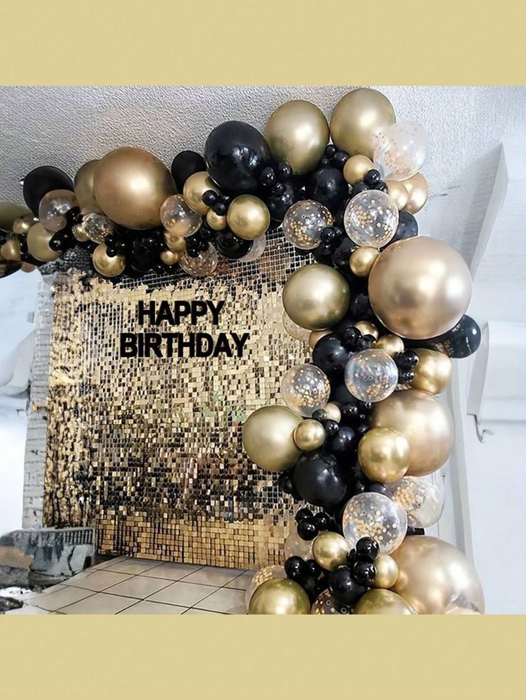 a happy birthday card surrounded by black, gold and silver balloons in the shape of a wreath