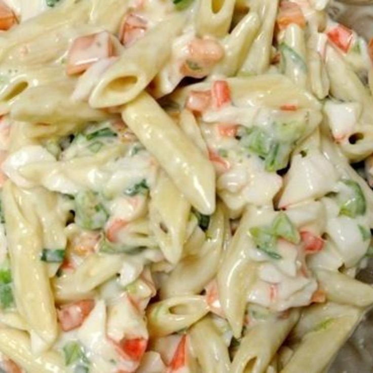 a pasta salad with shrimp and broccoli in it