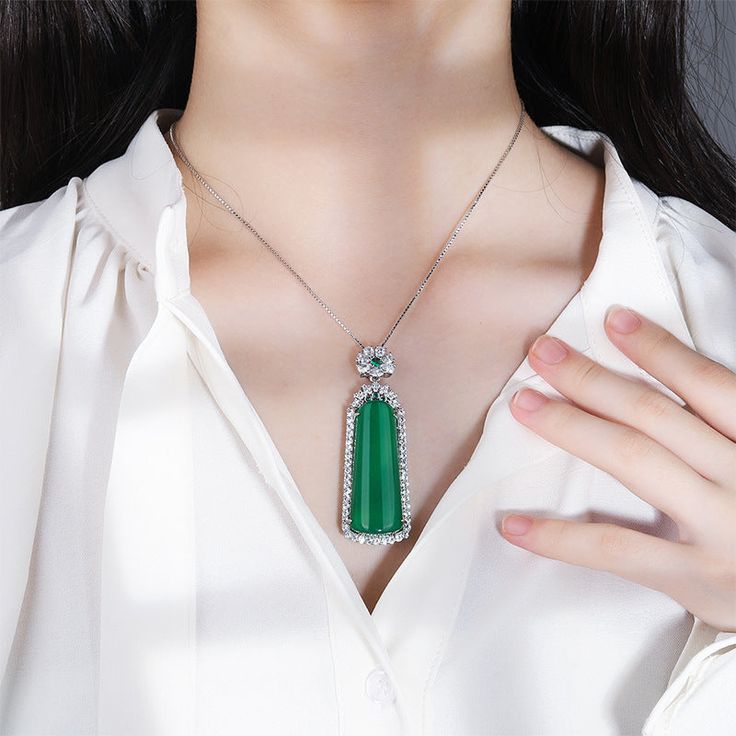 This Diamond Natural Emerald Jade Stone Pendant Necklace uses a carefully selected combination of stones to create a stunning accessory. It features a sparkling diamond combined with emerald jade to create a piece that exudes elegance and sophistication. Perfect for any special occasion or simply to add a touch of glamour to everyday wear.

Natural Emerald Jade Stone
Pendant size: 20*60mm
Chain length: 40CM (+ 5cm adjustable chain)
Weight: about 19.4g
Hypoallergenic, lead and nickel free

If you Luxury Jade Necklace For Formal Occasions, Luxury Formal Jade Necklace, Luxury Jade Necklace For Gift, Formal Fine Jewelry Jade Necklace, Diamond Emerald Pendant Necklace, Elegant Diamond Emerald Necklace, Exquisite Emerald Necklace With Diamond, Formal Green Emerald Gemstone Necklace, Elegant Emerald Gemstone Necklace For Party