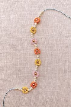 a beaded necklace with flowers on it