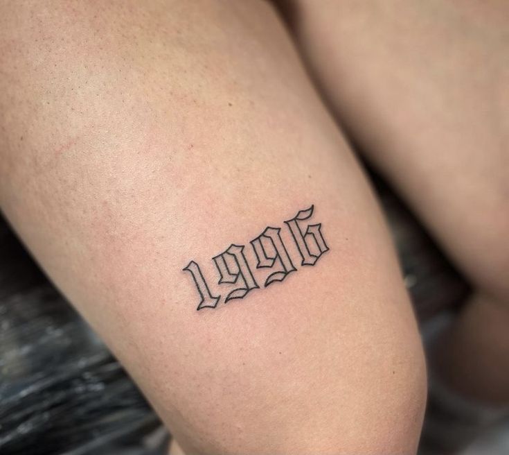 a woman's thigh with the word love tattooed on it in cursive font