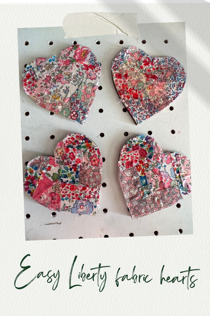 three heart shaped paper pieces sitting on top of a polka dot covered sheet with the words easy liberty hearts