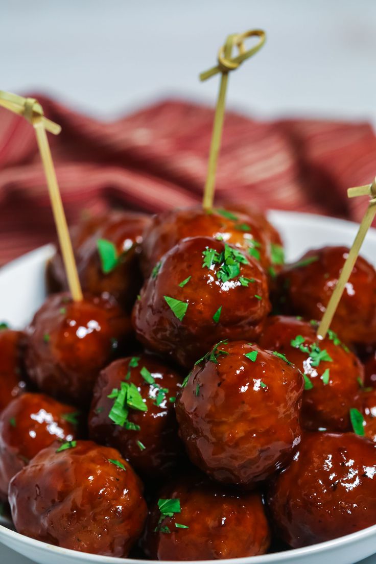 meatballs with toothpicks and carrots on a red plate