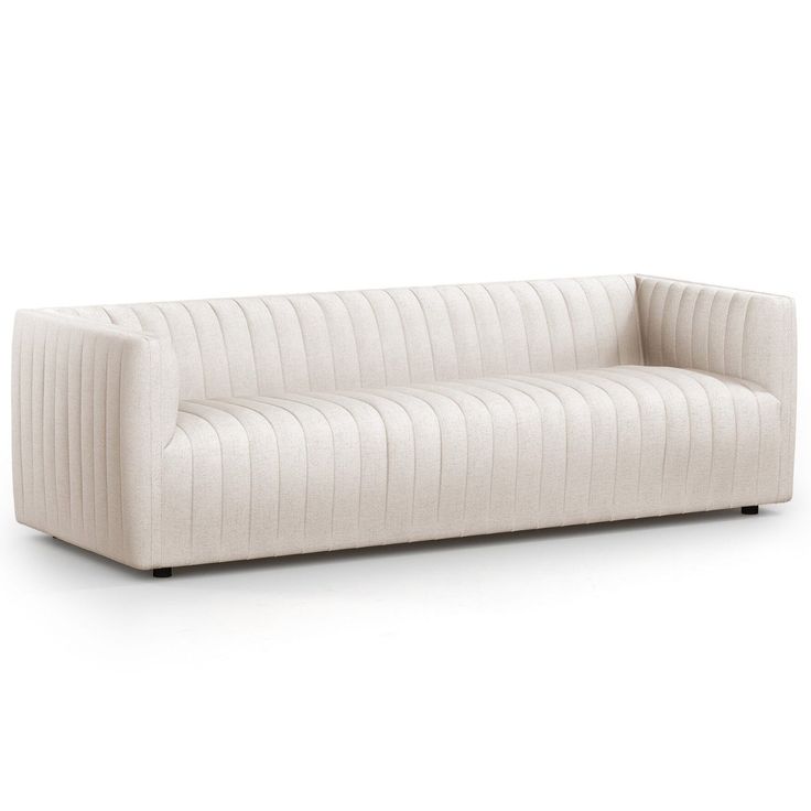 a white couch sitting on top of a white floor