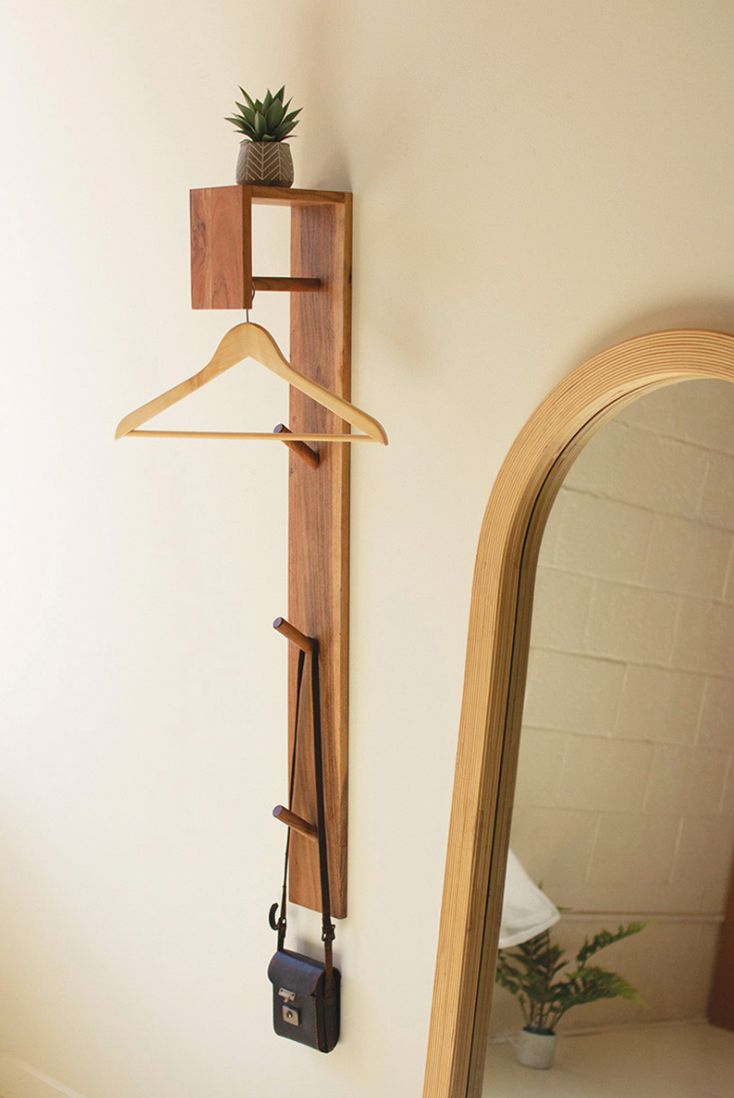 a mirror and coat rack on the wall