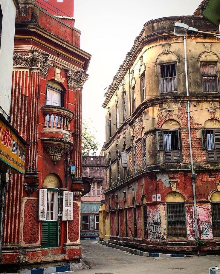 an old building with graffiti on the side of it's windows and balconies