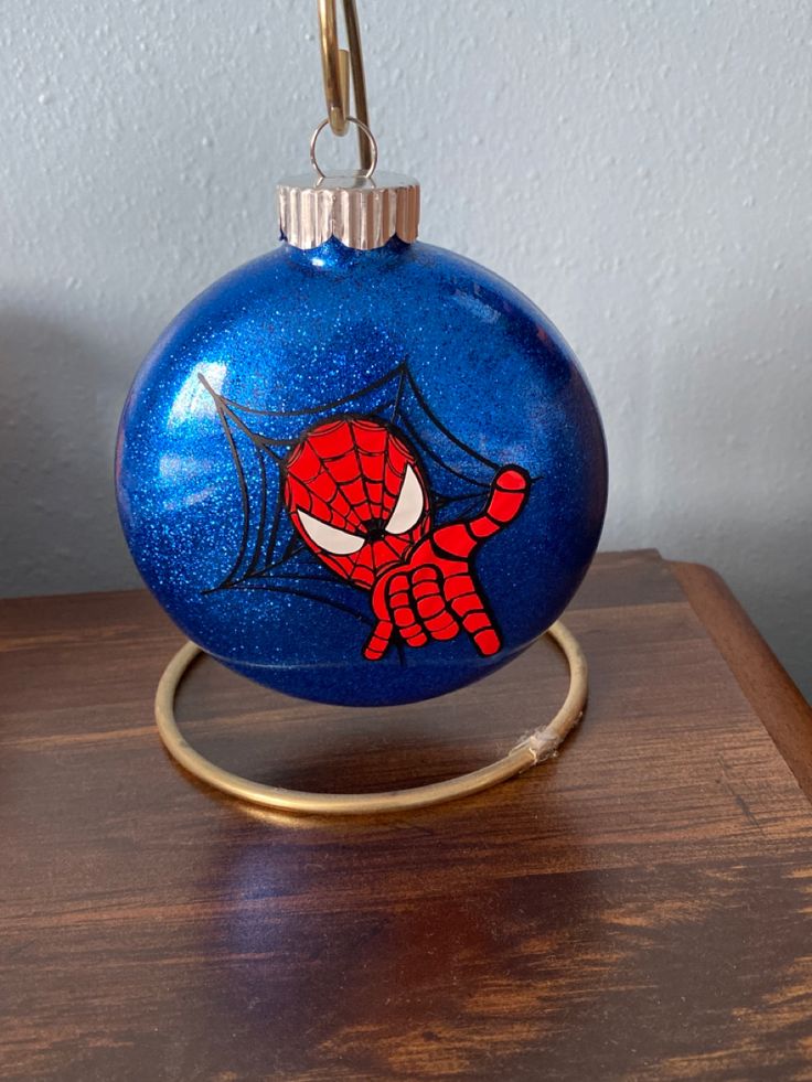 a blue ornament with a spiderman face on it