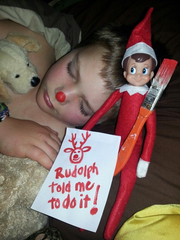 an elf is sleeping next to a teddy bear and a sign that says rudolph told me to do it