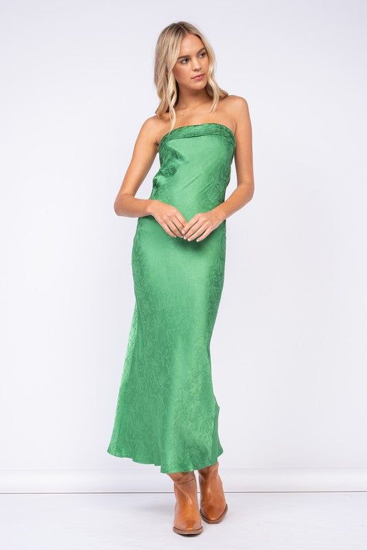 Final Sale - Get it before it's gone! Go to your next formal event wearing the Marla Green Floral Satin Strapless Maxi Dress! Green floral satin fabric shapes this maxi dress with a strapless neckline and an open back. Features a ruched elastic strap in the back - style with your favorite heels and jewelry for a chic formal look! DETAILS & FIT S: 50" Length, " 29 Bust, 28" Waist, 34" Hips M: 51.5" Length, 30" Bust, 30" Waist, 36" Hips L: 52" Length, 31" Bust, 32" Waist, 38" Hips 55% Viscose, 45% Strapless Satin Dress For Date Night In Spring, Strapless Satin Maxi Dress For Prom, Strapless Satin Dress With Ruched Bodice For Gala, Spring One-shoulder Satin Maxi Dress, Strapless Maxi Dress For Gala During Prom Season, Green Strapless Satin Dress, Strapless Satin Maxi Dress For Gala, Green Satin Strapless Dress For Summer, Green Ruched Satin Maxi Dress