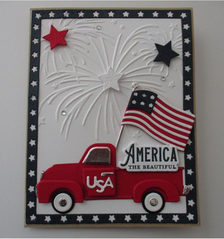 a red truck with an american flag on it's back and fireworks in the background