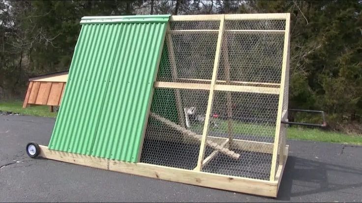 a large green chicken coop sitting on top of a parking lot