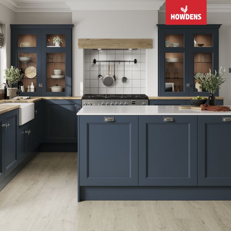 an image of a kitchen setting with blue cabinets and wood flooring on the walls