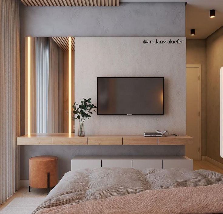 a flat screen tv mounted to the side of a wall above a bed in a bedroom