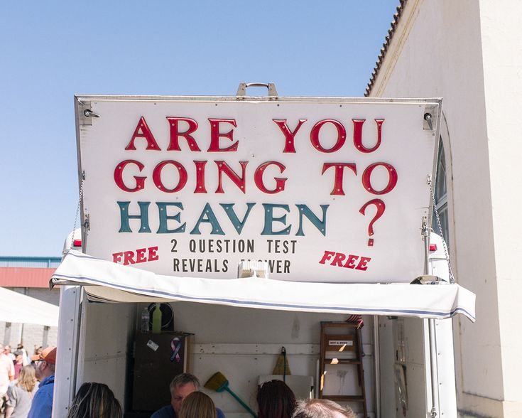 people are standing in front of a sign that says are you going to heaven?