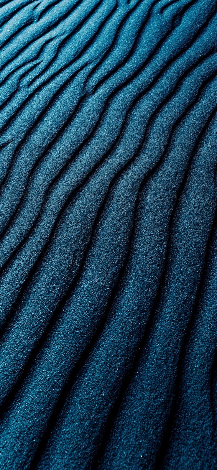 the blue sand is very wavy and has ridges that are made out of it's surface