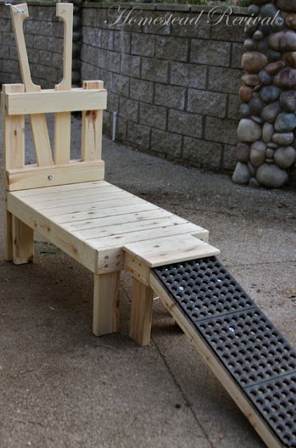 a bench made out of pallet wood with an iron grate attached to it