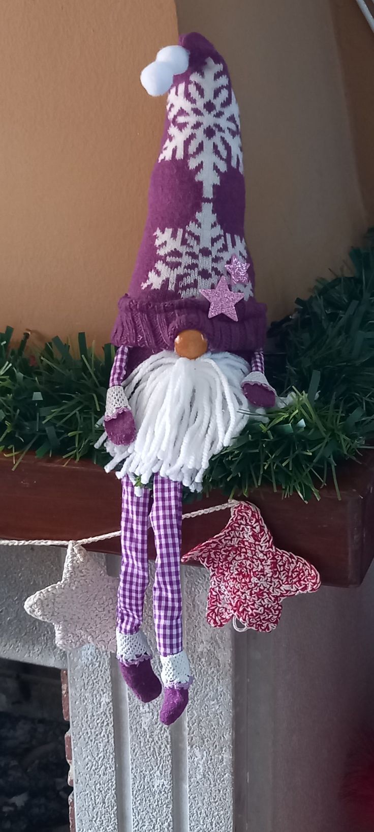 a purple and white snowflake gnome decoration