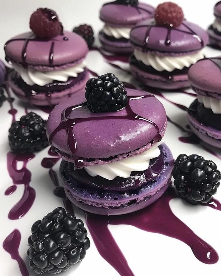 purple macaroons with blackberries on them and drizzled in syrup