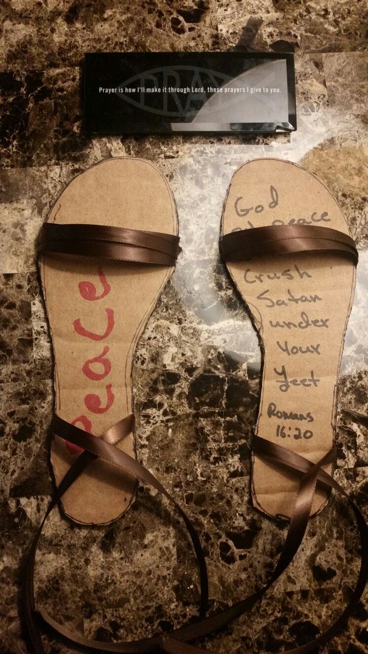 two pairs of sandals that have been made out of paper with writing on the bottom