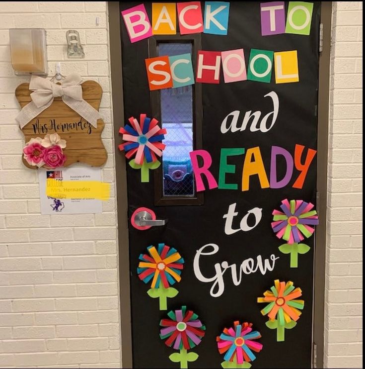 a door decorated with flowers and the words back to school and ready to grow