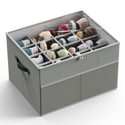 a large gray storage box filled with lots of pairs of shoes on top of it