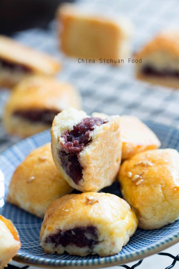 small pastries on a blue plate with other pastries in the backgroud