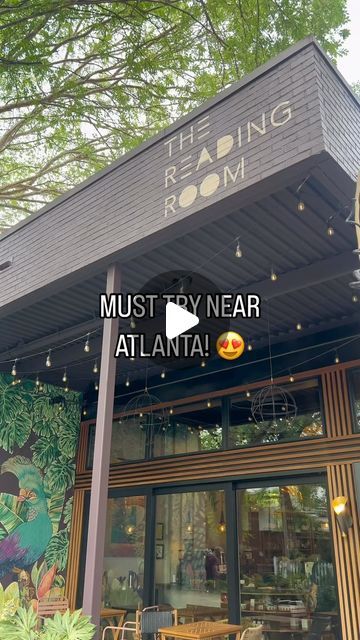 the reading room in atlanta is decorated with murals and lights for an outdoor dining area