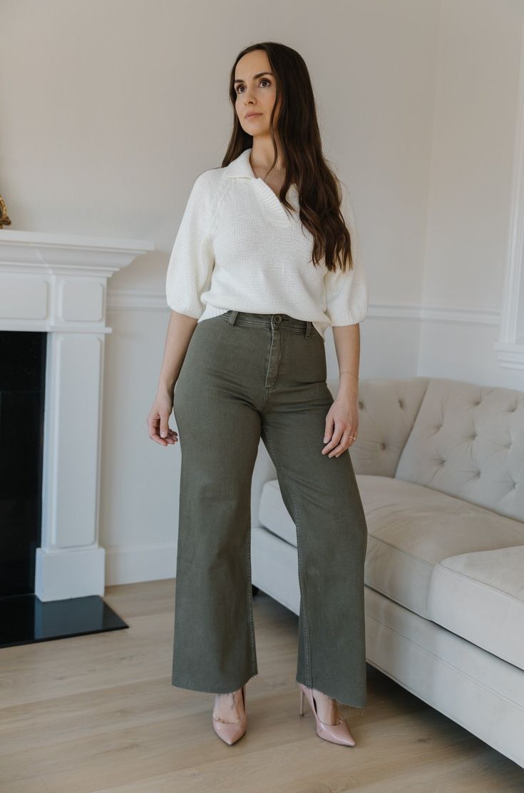 The Olive Green Wide Leg Jeans are an essential addition to any wardrobe. These classic jeans feature a flattering high waist, wide leg fit, and cropped style that flatters your figure and ensures comfort and flexibility throughout the day. Perfect for all seasons, these jeans provide timeless elegance and style. olive green wide leg pants high waist comfort stretch raw hem 98% cotton 2% spandex machine wash cold model is wearing a small SIZING CHART FOR THE JEANS: Small: fits sizing 25-26 Mediu Wide-leg Cotton Cropped Jeans For Fall, Cotton Wide Leg Cropped Jeans For Fall, Fall Wide-leg Cropped Jeans, High Waist Relaxed Fit Jeans For Business Casual, Fall Cotton Wide-leg Cropped Jeans, Mid-rise Wide Leg Pants For Everyday Fall Wear, Chic Wide-leg Cropped Jeans For Fall, Chic Cropped Wide-leg Jeans For Fall, Chic Fall Cropped Wide-leg Jeans