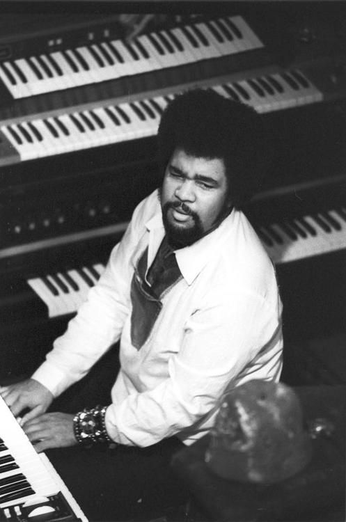 a man sitting in front of an organ keyboard