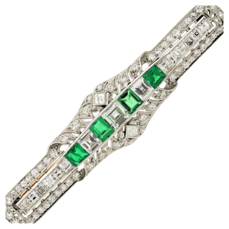 A top-quality brooch with fine gem emerald and diamonds made in the early Art Deco movement, circa 1925. It is an early Art Deco piece as it has some elements of Edwardian era garland motifs on the outer top and bottom of the piece while the center of the brooch has the geometric straight line Deco style. It features 3 carats of bright white round and square-shaped diamonds along with 4 luscious green emeralds weighing 1 carat total. Hand-fabricated in platinum with a gold pin catch, a piece of Art Deco Diamond Brooch, Antique Pins, Art Deco Brooch, Edwardian Jewelry, Gold Pin, Style Deco, Jewelry Picture, Diamond Brooch, Estilo Art Deco