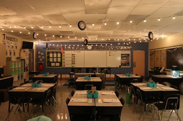 an empty classroom with desks and lights on the ceiling is pictured in this image