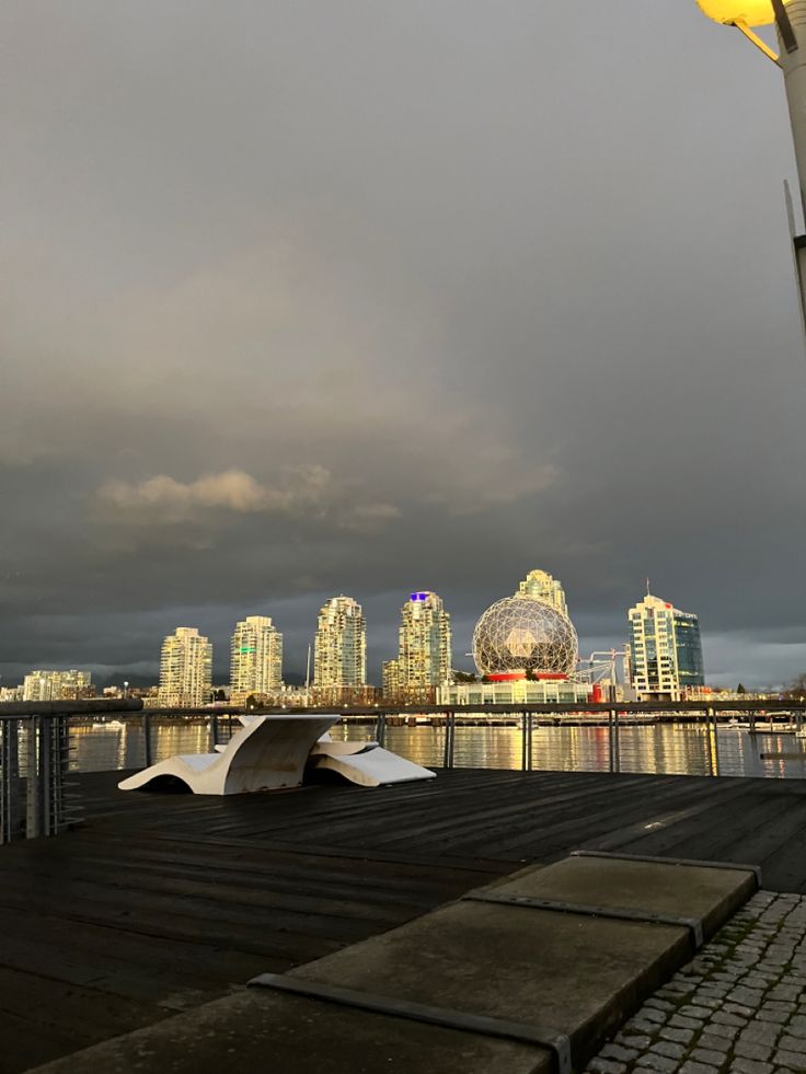 a cloudy sky over the city and water