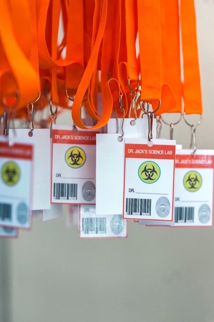 several tags hang from a rack with orange lanyards