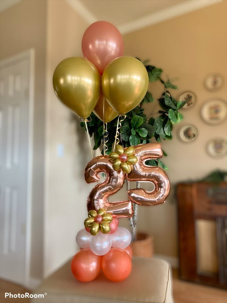 the number twenty five balloons are in the shape of flowers and numbers on top of each balloon