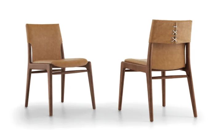 two brown chairs sitting next to each other