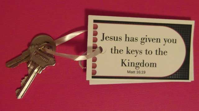 a key chain attached to a pink wall with a bible verse on it that says jesus has given you the keys to the kingdom