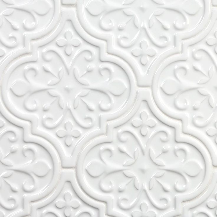 a white wall with an intricate design on it