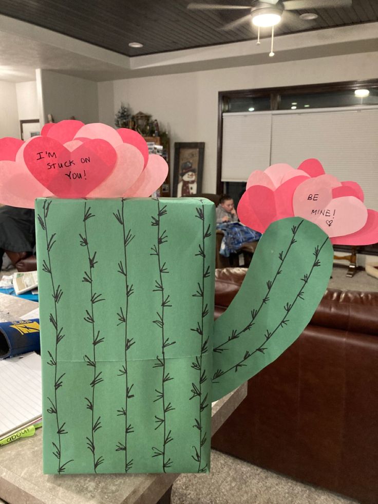 a cactus with paper hearts attached to it