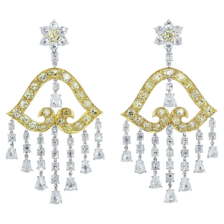 Impressive 27.90 carats of yellow diamond and white diamond chandelier earrings crafted in platinum and 18 karat yellow gold. The earrings have 13.89 carats of fancy yellow diamonds set in 18 karat yellow gold and 13.01 carats of white diamonds set in platinum. The earrings are designed with white diamond flower petals and a yellow diamond flower center. Connected with a single round brilliant diamond is a beautifully shaped bell crafted in 18 karat yellow gold with striking yellow diamonds. Sus Diamond Carat Size Chart, Carat Size Chart, Diamond Carat Size, Water Opal, Diamond Tops, Diamond Chandelier Earrings, Diamond Chandelier, Cognac Diamonds, Yellow Diamonds