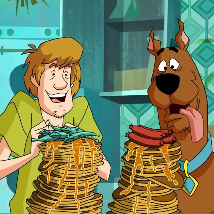 scooby and his friend have stacks of pancakes in front of him